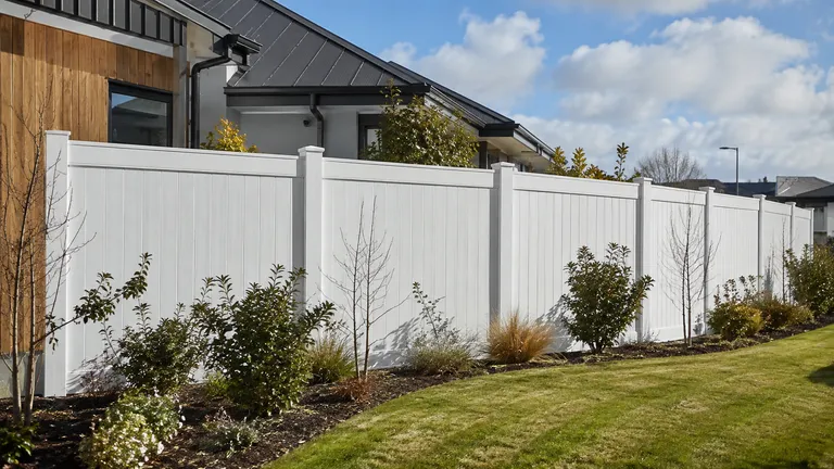 Clean PVC boundary fence beside a contemporary Christchurch home